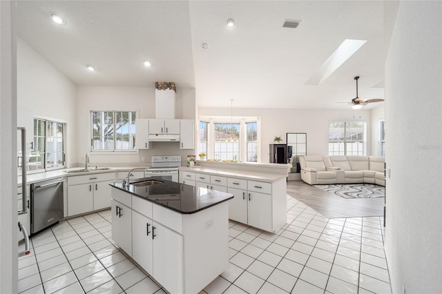 kitchen with a center island, under cabinet range hood, stainless steel dishwasher, a sink, and white range with electric cooktop