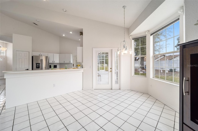 unfurnished dining area featuring a chandelier and lofted ceiling
