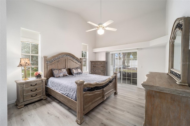 bedroom with access to outside, high vaulted ceiling, light wood finished floors, and ceiling fan