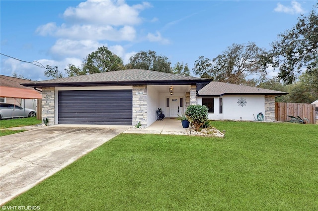 view of front of property with a front yard and a garage