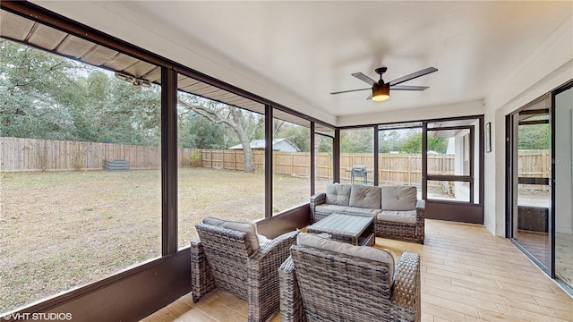 sunroom / solarium featuring ceiling fan