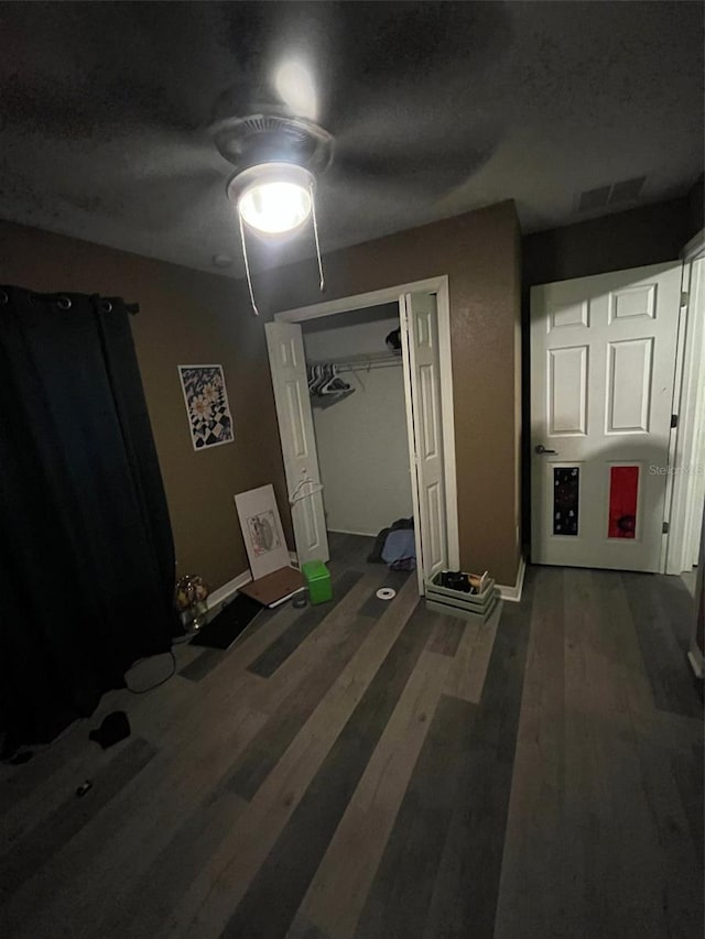 hallway featuring a textured ceiling and dark wood-type flooring