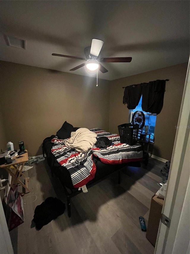 bedroom with ceiling fan and hardwood / wood-style floors