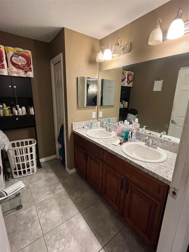 bathroom featuring a textured ceiling, tile patterned flooring, and vanity