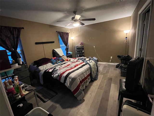 bedroom featuring ceiling fan and wood-type flooring