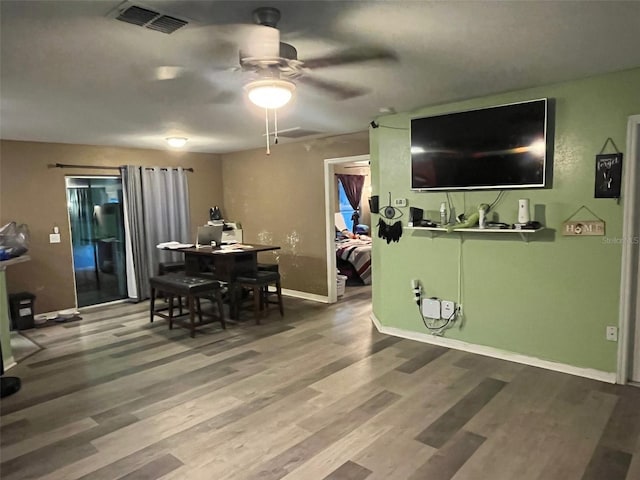 dining room with ceiling fan and wood-type flooring