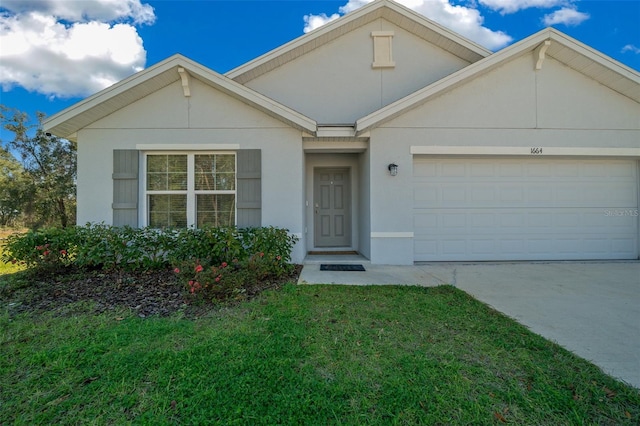 view of front of property featuring a garage and a front yard