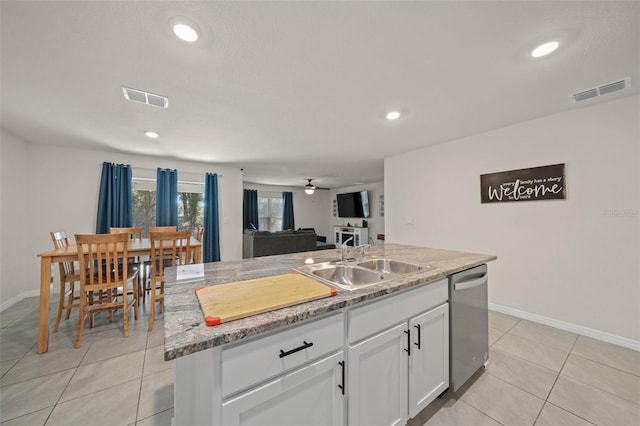 kitchen with white cabinets, ceiling fan, sink, dishwasher, and an island with sink