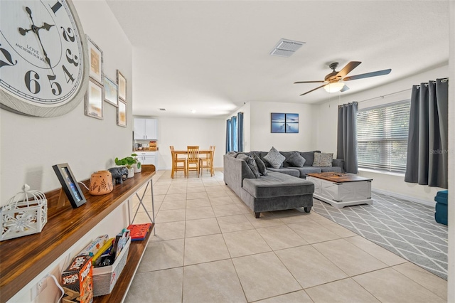 living room featuring ceiling fan and light tile patterned floors