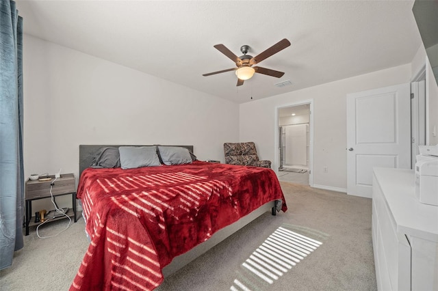 carpeted bedroom featuring ensuite bathroom and ceiling fan