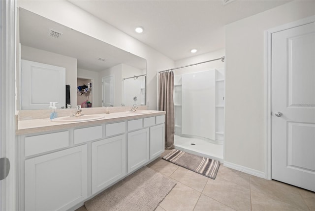 bathroom with a shower with shower curtain, vanity, and tile patterned floors