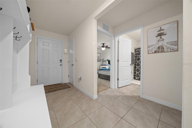 interior space featuring ceiling fan and light tile patterned floors