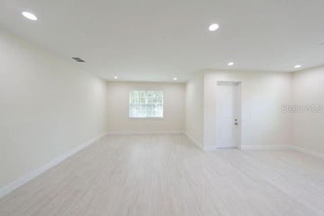 spare room with light hardwood / wood-style floors