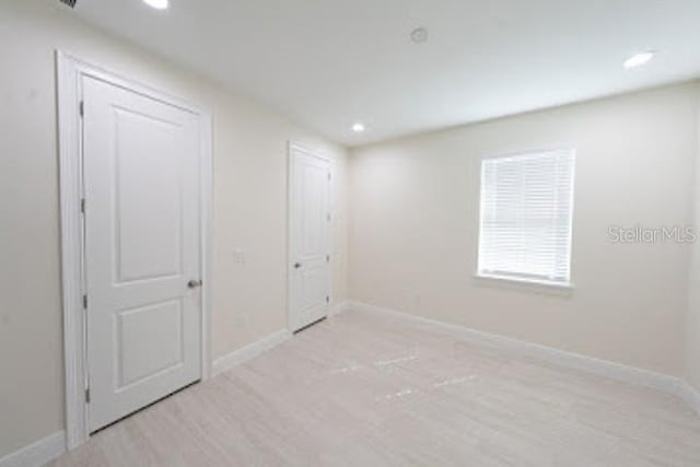 unfurnished bedroom featuring light wood-type flooring