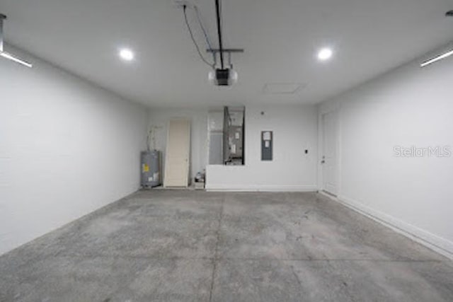 garage with electric water heater, electric panel, and a garage door opener