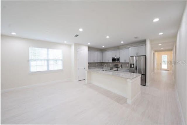 kitchen with recessed lighting, stainless steel appliances, baseboards, and tasteful backsplash