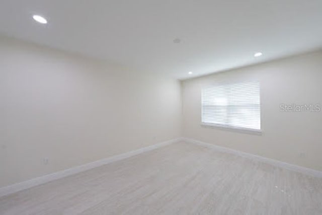 spare room featuring light wood-type flooring