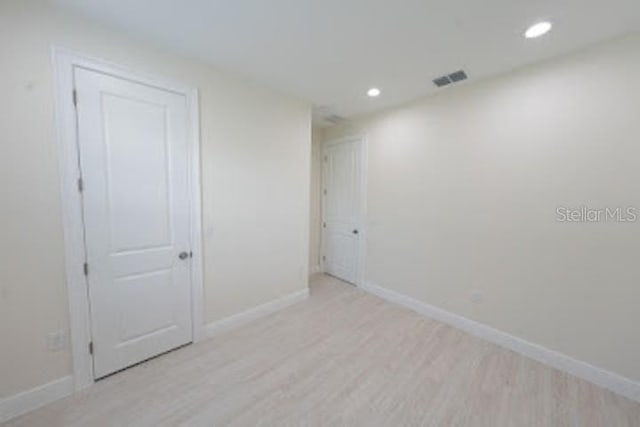 spare room with light hardwood / wood-style floors