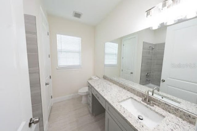 bathroom with vanity and toilet