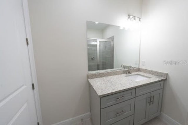 bathroom with vanity and walk in shower