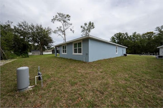 view of property exterior featuring a lawn