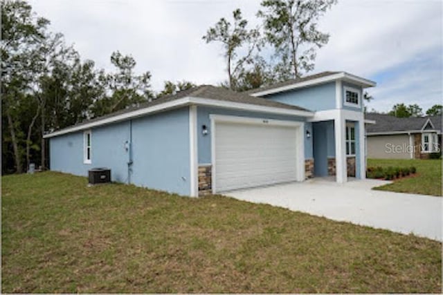 view of front of house with a garage and a front yard