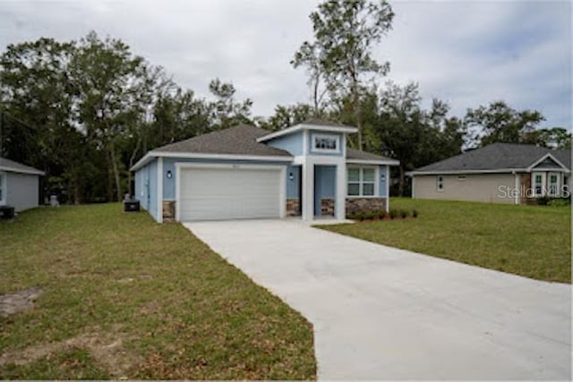 view of front facade with a front yard and a garage