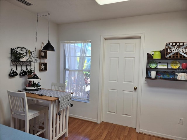 dining space with hardwood / wood-style floors