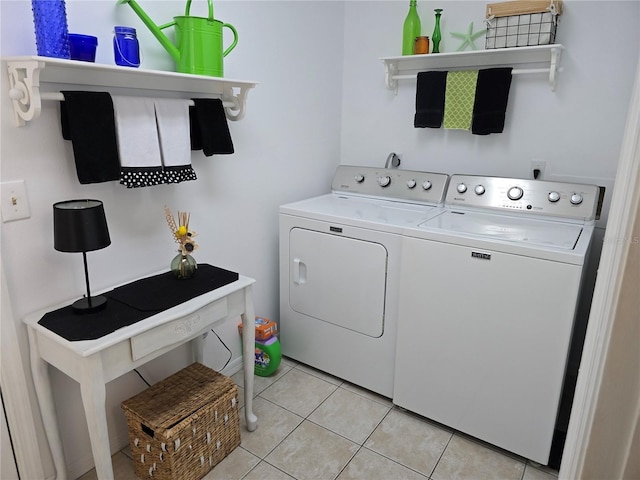 washroom with light tile patterned floors and separate washer and dryer