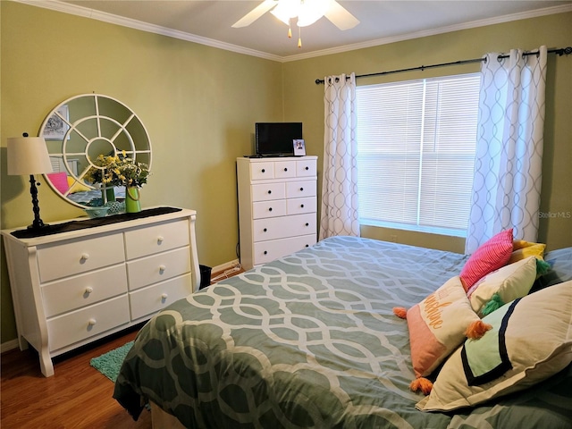 bedroom featuring ceiling fan, ornamental molding, and hardwood / wood-style flooring