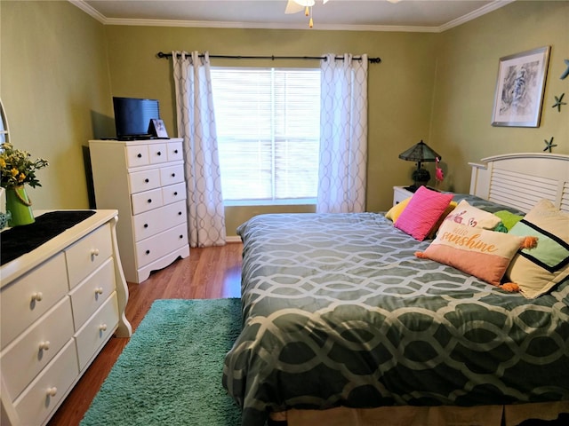 bedroom with ornamental molding and hardwood / wood-style flooring