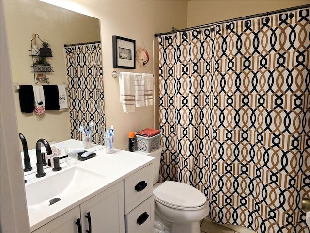 bathroom with vanity, a shower with shower curtain, and toilet