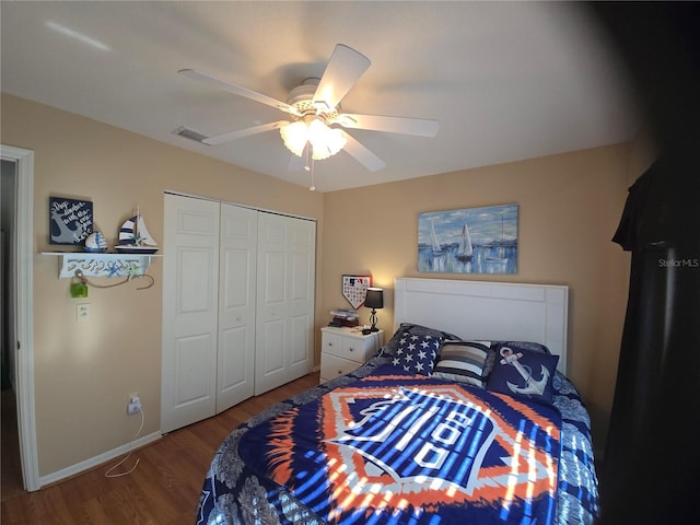 bedroom with hardwood / wood-style floors, a closet, and ceiling fan