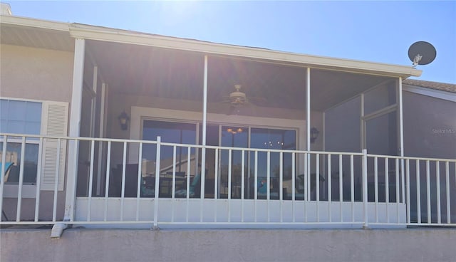 view of property exterior featuring a sunroom and ceiling fan