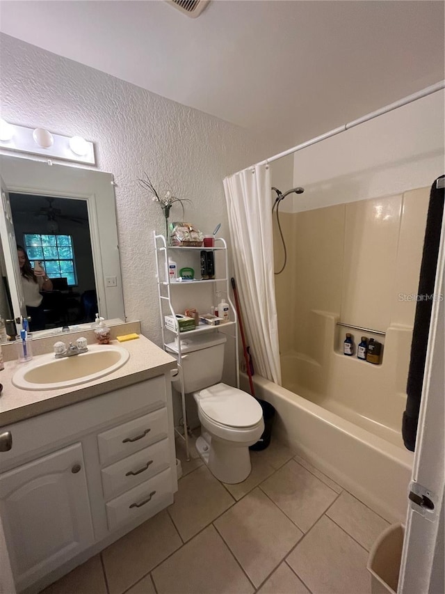 full bathroom with toilet, shower / bathtub combination with curtain, tile patterned floors, and vanity