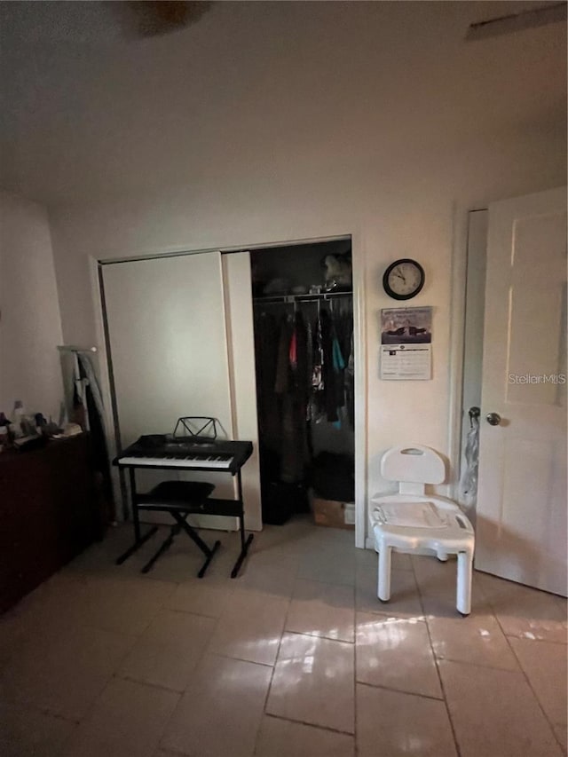 interior space with a closet and light tile patterned floors