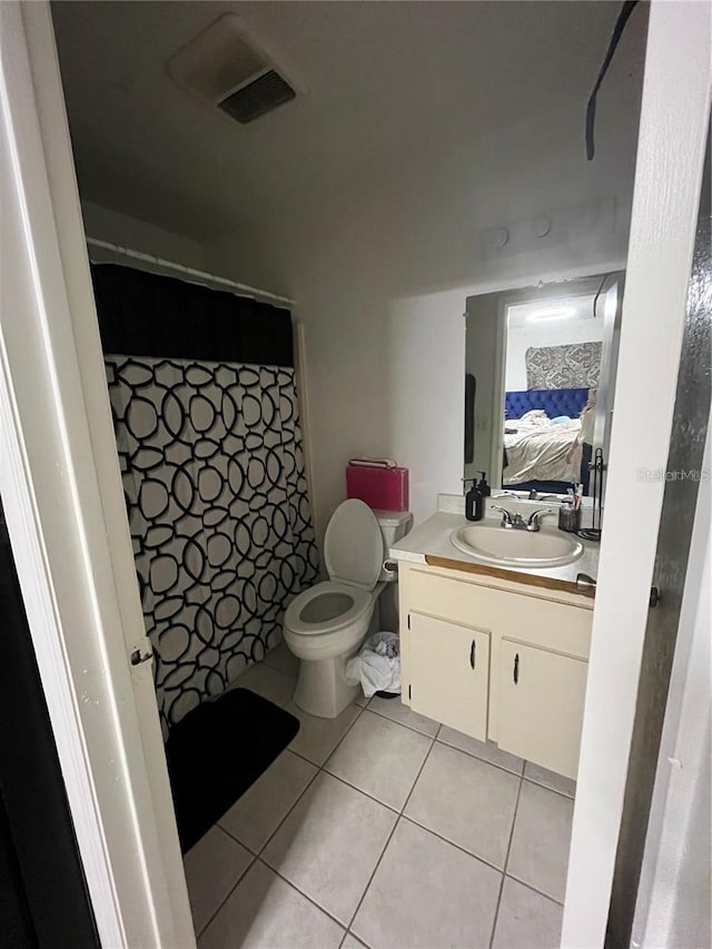 bathroom featuring tile patterned flooring, vanity, and toilet