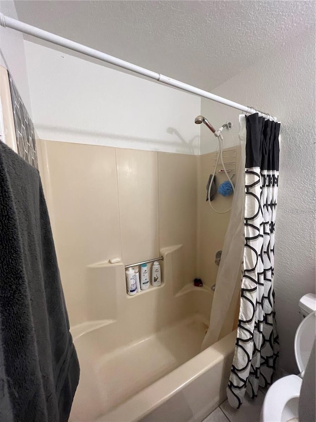 bathroom featuring shower / bathtub combination with curtain and toilet