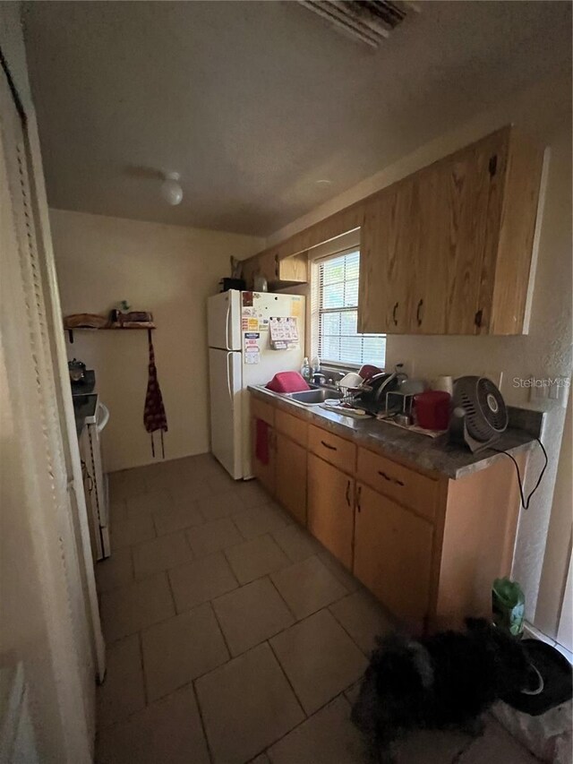 kitchen featuring white appliances and sink