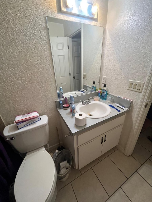 bathroom featuring tile patterned flooring, vanity, and toilet