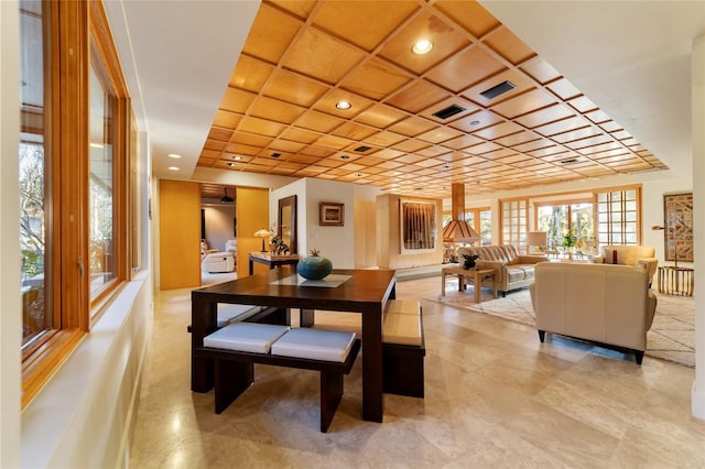 dining area featuring coffered ceiling