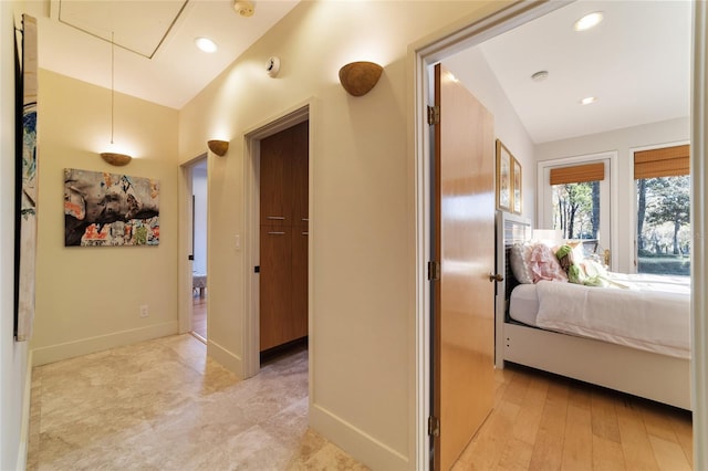 hallway with light hardwood / wood-style floors