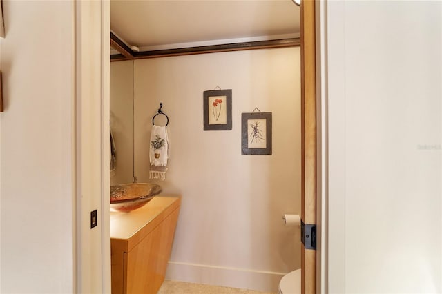 bathroom with tile patterned flooring, vanity, and toilet