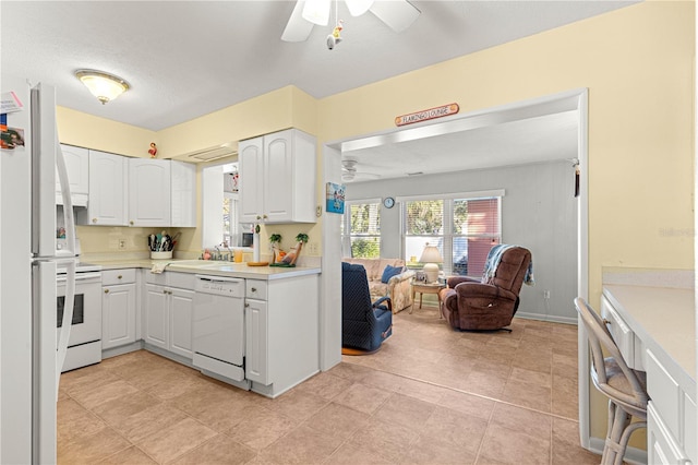 kitchen featuring ceiling fan, sink, white cabinets, and white appliances