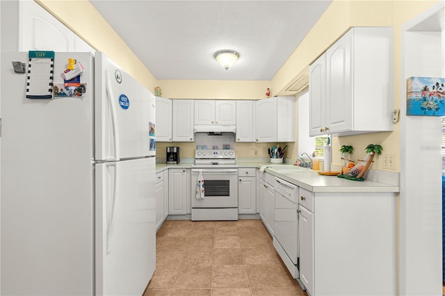 kitchen featuring a textured ceiling, white appliances, white cabinetry, and sink