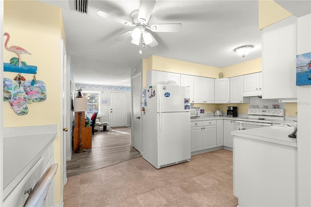 kitchen with ceiling fan, white cabinetry, white appliances, and a textured ceiling