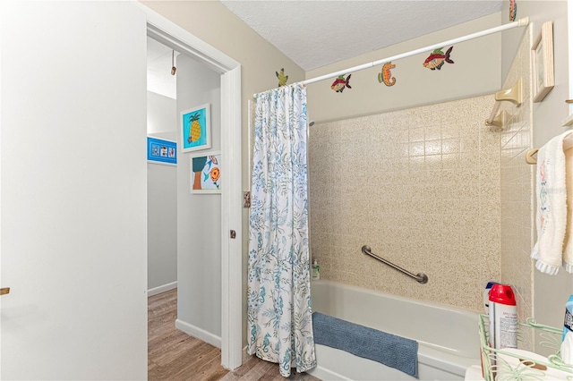 bathroom with wood-type flooring, a textured ceiling, and shower / bathtub combination with curtain