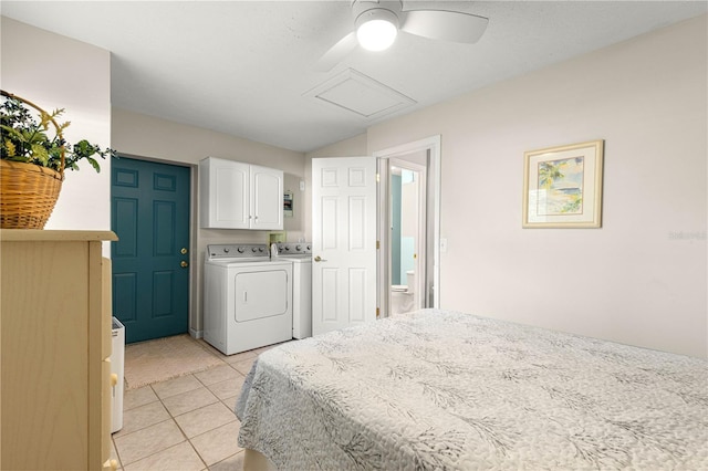 tiled bedroom featuring washing machine and dryer, ceiling fan, and ensuite bath