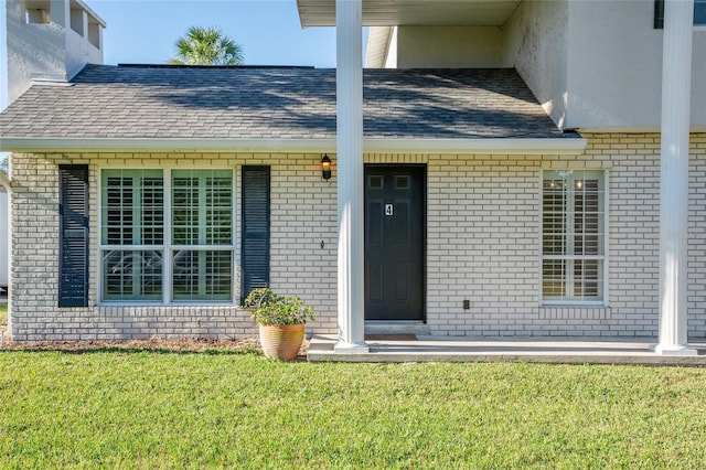 property entrance featuring a lawn