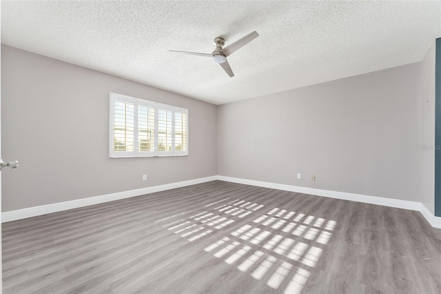 spare room with a textured ceiling, light hardwood / wood-style flooring, and ceiling fan